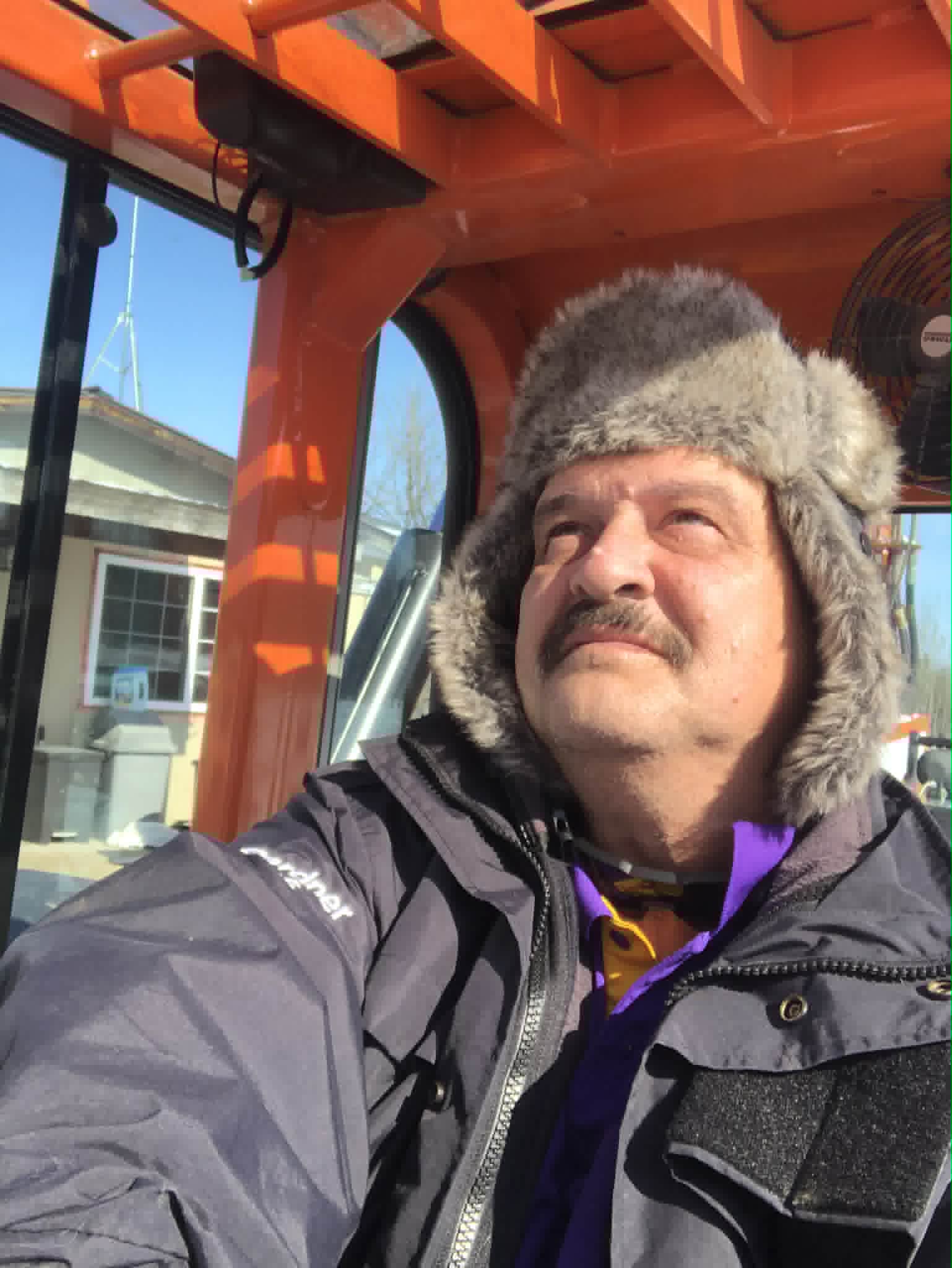 Chris in a tractor cab in winter